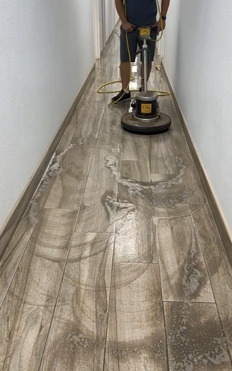 Wood-look vinyl hallway floor before acid wash